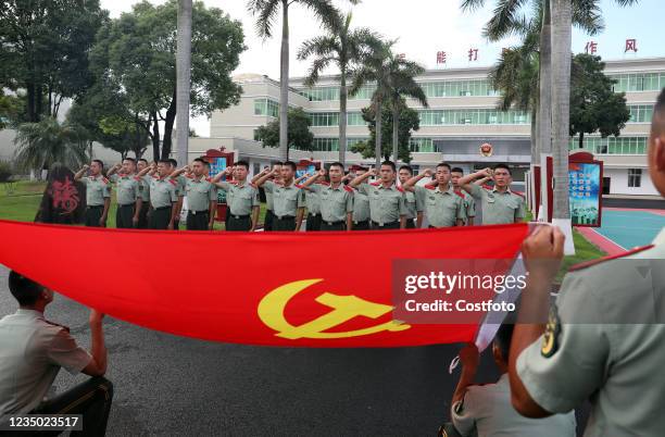Armed police officers review their pledge to join the Communist Party of China in Qinzhou, South China's Guangxi Zhuang Autonomous Region, Sept. 2,...