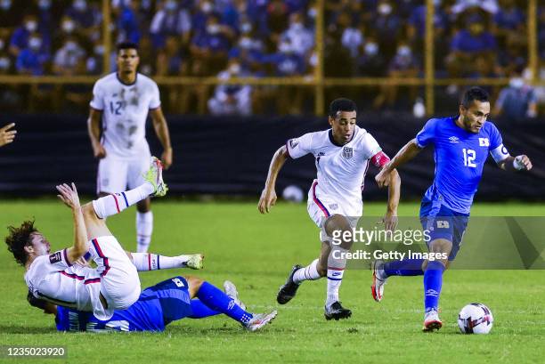 Marvin Monterrosa of El Salvador drives the ball while followed by Tyler Adams of the United States during a match between El Salvador and United...