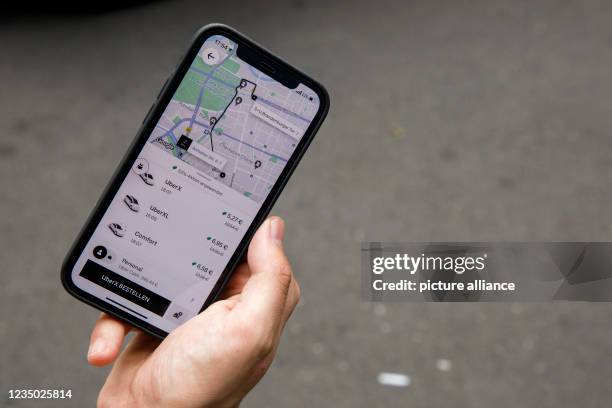 September 2021, Berlin: The mobile app for ordering an Uber car is seen on a smartphone. Photo: Carsten Koall/dpa