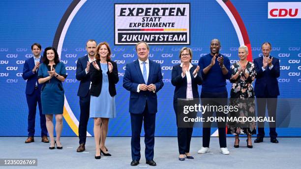 North Rhine-Westphalia's State Premier and Germany's conservative Christian Democratic Union's chancellor candidate Armin Laschet poses with members...