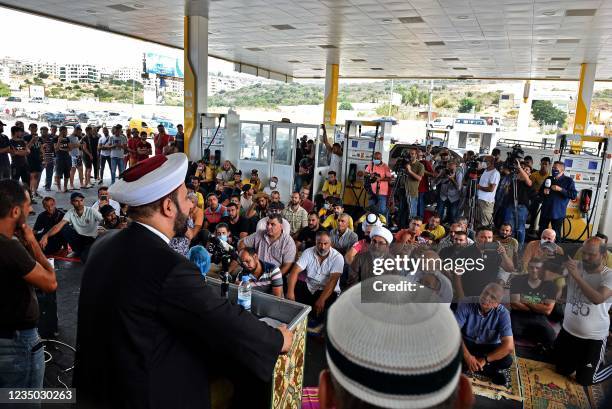 Sunni Muslim cleric delivers a 'Khutab' during the Friday prayers, held in a petrol station south of the Lebanese capital Beirut, on September 3 amid...