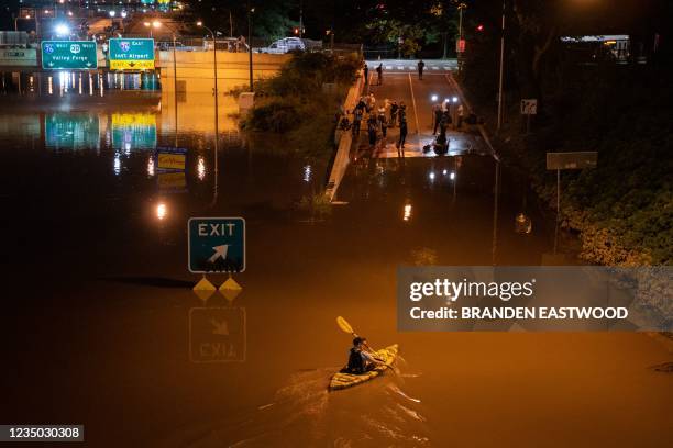 Kayaker paddels down a portion of Interstate 676 after flooding from heavy rains from hurricane Ida in Philadelphia, Pennsylvania on September 2,...