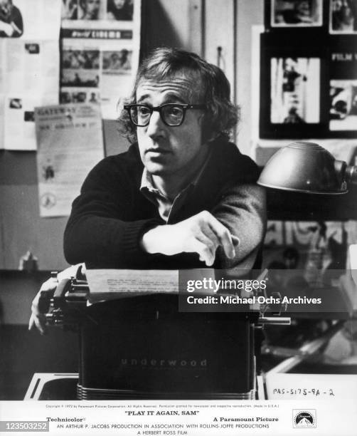 Woody Allen with his arms resting on a typewriter in a scene from the film 'Play It Again, Sam', 1972.