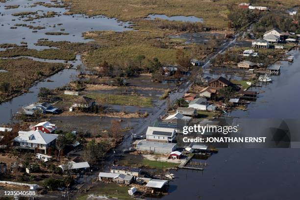 View of flood damaged buildings are seen as US President Joe Biden inspects the damage from Hurricane Ida onboard Marine One during an aerial tour of...