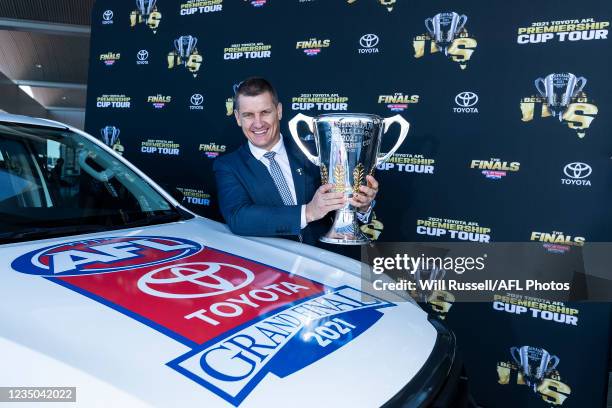 Premiership Cup Ambassador Glen Jakovich poses with the Premiership Cup during the Premiership Cup Tour Launch at the Grand Toyota Dealership on...