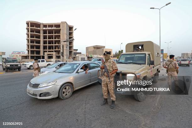 Libyan soldiers man a checkpoint southeast of the capital Tripoli, on September 4 after clashes near the Tekbali barracks, the headquarters of 444...