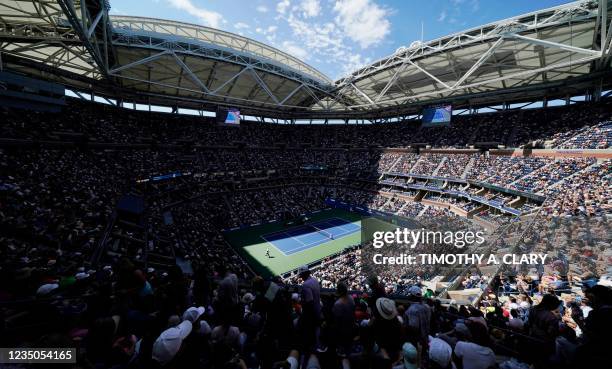 Fans watch the match between Serbia's Novak Djokovic and Japan's Kei Nishikori at Arthur Ashe Stadium during the 2021 US Open Tennis tournament men's...