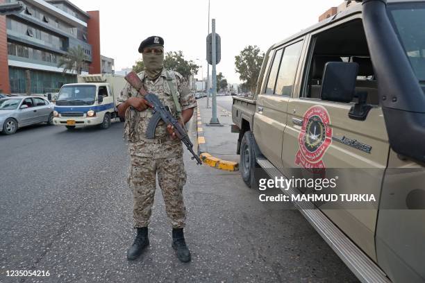 Libyan soldier mans a checkpoint southeast of the capital Tripoli, on September 4 after clashes near the Tekbali barracks, the headquarters of 444...