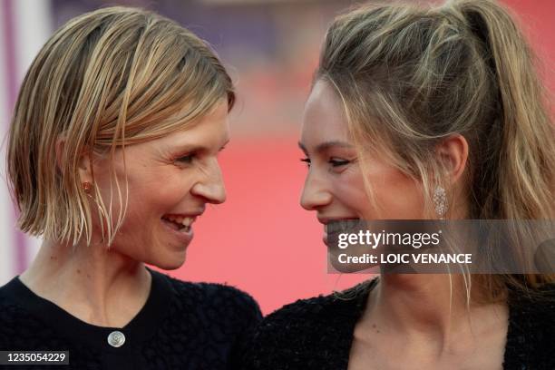 Actress Dylan Penn poses with French actress Clemence Poesy on the red carpet to receive the New Hollywood Price during the 47th Deauville US Film...