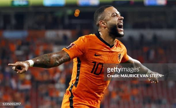Memphis Depay of Holland celebrates scoring his second goal during the World Cup qualifier football match between the Netherlands and Montenegro on...
