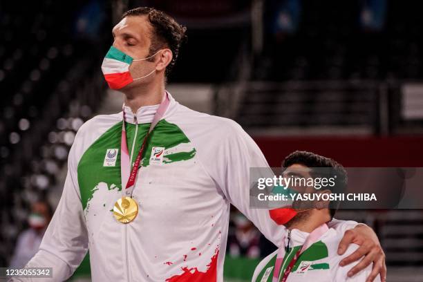 Morteza Mahrzadselakjani listens the national anthem during the victory ceremony after the final match of sitting volleyball between the Russian...