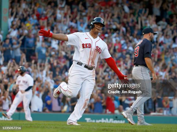 Rafael Devers of the Boston Red Sox reacts after he hit a three-run home against the Cleveland Indians in the seventh inning at Fenway Park on...