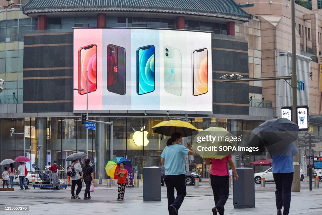 IPhone smartphones seen displayed on a large screen outside...