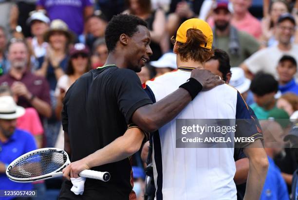 Italy's Jannik Sinner greets France's Gael Monfils at the net after winning their 2021 US Open Tennis tournament men's singles third round match at...