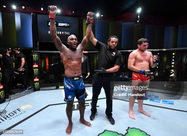 In this handout image provided by UFC, Derek Brunson reacts after his submission victory over Darren Till of England in their middleweight fight...