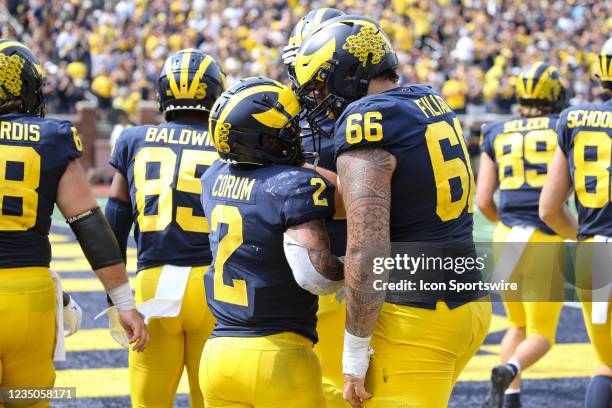 Michigan Wolverines running back Blake Corum celebrates in the end zone with Michigan Wolverines offensive lineman Chuck Filiaga after scoring a...