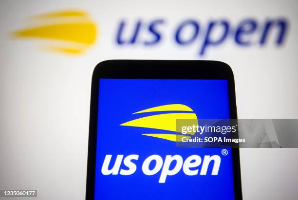 In this photo illustration the US Open logo is seen on a smartphone and a pc screen.