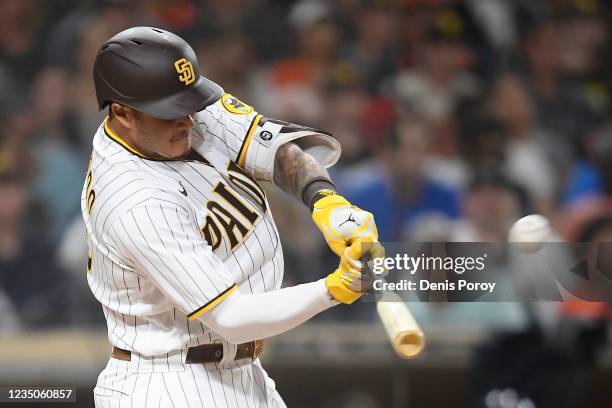 Manny Machado of the San Diego Padres hits a two-run home run during the seventh inning of a baseball game against the Houston Astros at Petco Park...