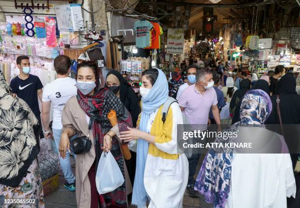 Iranians wearing face masks as protection from Covid-19, shop at the Grand Bazaar of Iran's capital Tehran on September 5, 2021.