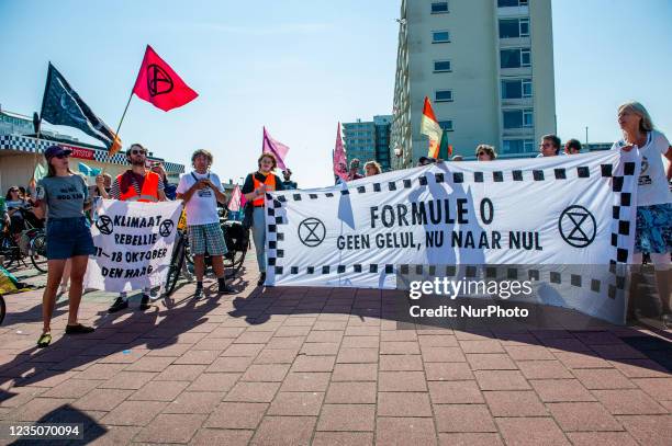 Extinction Rebellion activists are holding a placard in the middle of the walking route to the Formule 1 circuit, during the Extinction Rebellion...