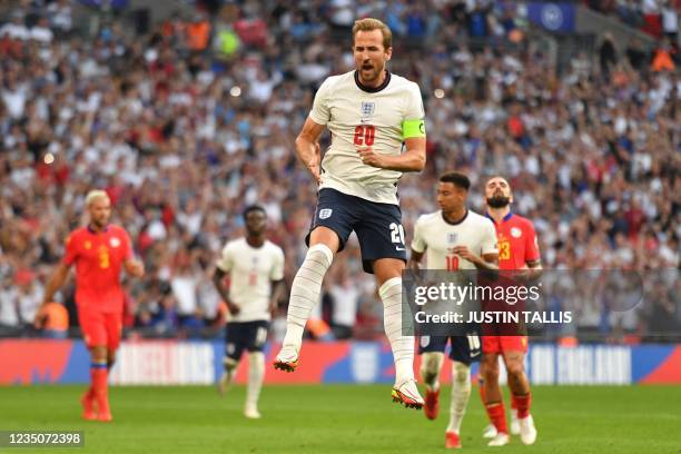 England's striker Harry Kane celebrates after scoring their second goal from the penalty spot during the FIFA World Cup 2022 qualifying match between...