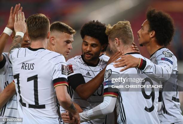 Germany's forward Marco Reus celebrates with teammates scoring the 3-0 during the FIFA World Cup Qatar 2022 qualification Group J football match...