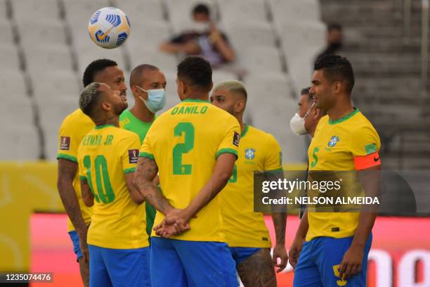 Brazil's team players are seen after employees of the National Health Surveillance Agency entered to the field during the South American...