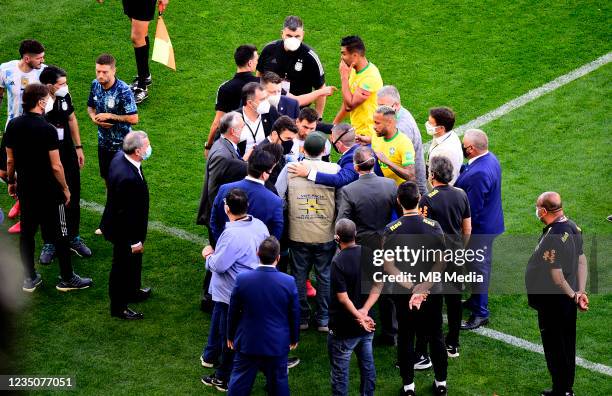 Health Staff of ANVISA of Brazil argue with Lionel Messi of Argentina and Neymar of Brazil on the field during a match between Brazil and Argentina...