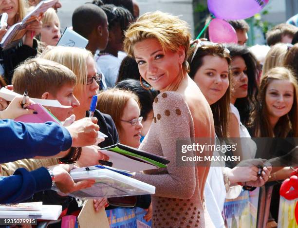 Sarah Harding from the group 'Girls Aloud' meets with fans as she arrives at the premiere of the film,' Horrid Henry', in central London on July 24,...