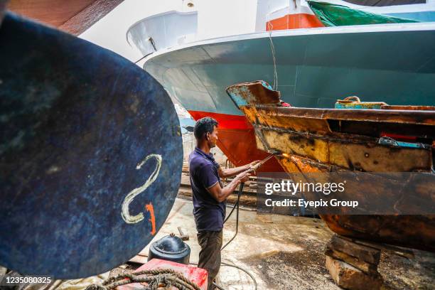 Bangladeshi worker welds a ship at a dockyard on the bank of River Buriganga, in Keraniganj, near Dhaka, With an increasing number of orders from...