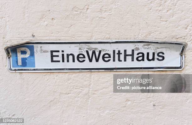 September 2021, Bavaria, Munich: In the courtyard of the One World House, a parking sign with the inscription "One World House" is attached to a...