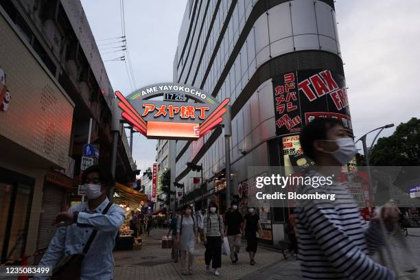 Pedestrians wearing protective face masks at the Ameyoko shopping street in Tokyo, Japan, on Sunday, Sept. 5, 2021. Prime Minister Yoshihide Suga's...