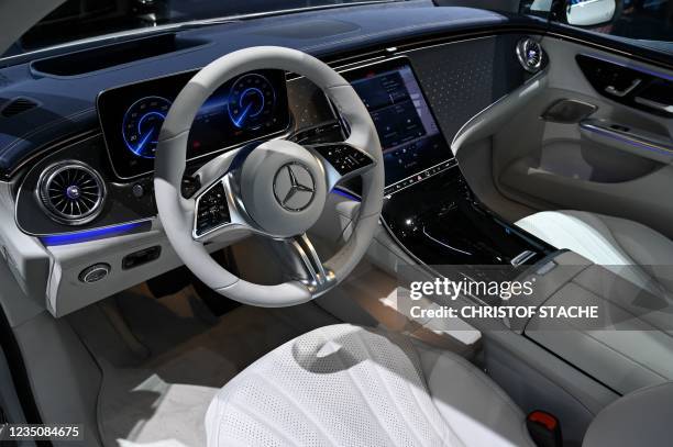 The logo of Mercedes-Benz can be seen on the steering wheel of a Mercedes EQE 350 car during a press preview at the International Motor Show , on...