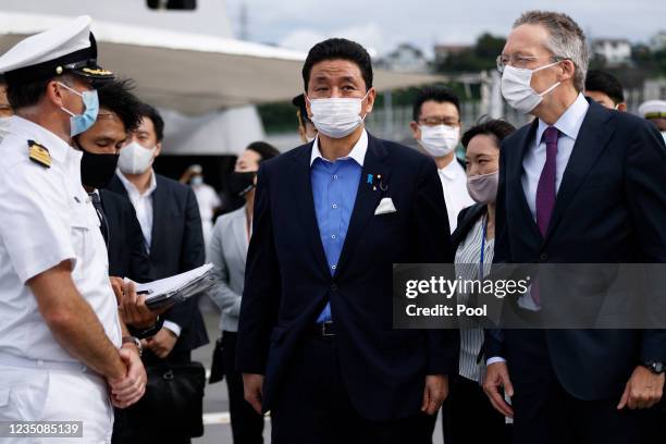 Nobuo Kishi, Japan's Defence Minister, centre, Peter van der Vliet, Netherlands' ambassador to Japan, right, and Rick Ongering, commanding officer of...