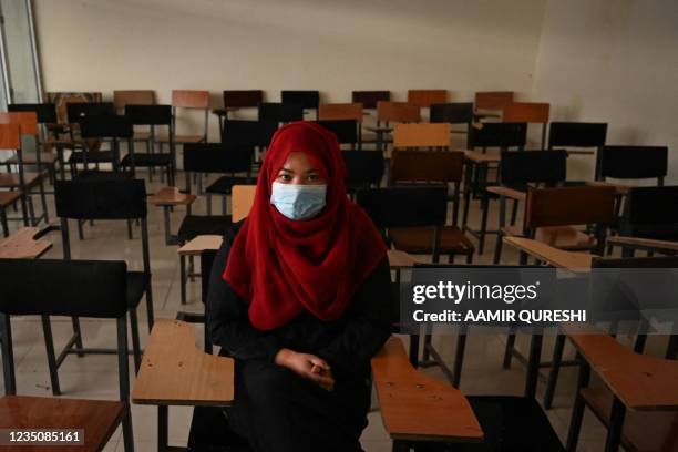 Student sits inside a classroom after private universities reopened in Kabul on September 6, 2021. - Women attending private Afghan universities must...