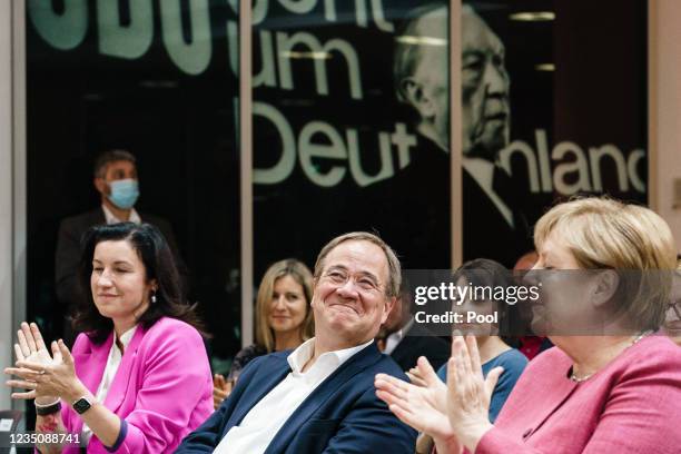 German Chancellor Angela Merkel and State Secretary for Digitalization Dorothee Baer applaud to Christian Democratic Union party chairman and top...