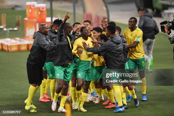 Bongokuhle Hlongwane of South Africa celebrates after scoring the first goal with team-mates during the 2022 FIFA World Cup Qualifier match between...