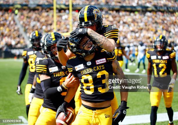 David Ungerer of the Hamilton Tiger-Cats celebrates scoring a touchdown during a CFL game agains the Toronto Argonauts at Tim Hortons Field on...