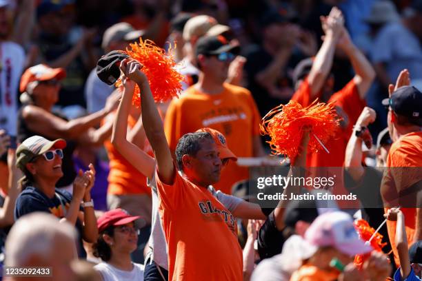 San Francisco Giants fans cheer after a home run by Buster Posey of the San Francisco Giants during the first inning against the Colorado Rockies at...