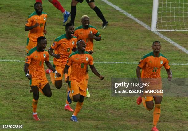 Ivorian national football team players celebrate after scoring a goal during the FIFA Qatar 2022 World Cup qualification football match between Ivory...