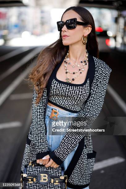 Influencer Sandra Bauknecht wearing a black and white jacquard cropped top with Balmain monogram by Balmain, a black and white jacquard cardigan with...