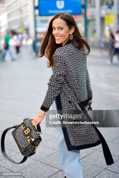 Influencer Sandra Bauknecht wearing a black and white jacquard cropped top with Balmain monogram by Balmain, a black and white jacquard cardigan with...
