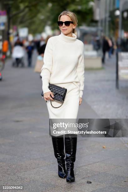 German TV host Tamara von Nayhauss wearing a cream colored knitted cashmere turtleneck pullover by The Mercer N.Y., a cream colored knitted cashmere...