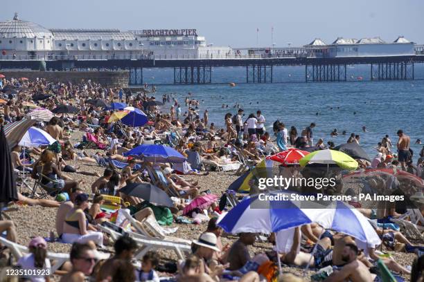 People enjoy the warm weather at Brighton beach in West Sussex. Temperatures are forecast to reach up to 30C in parts of the UK on Tuesday as the...