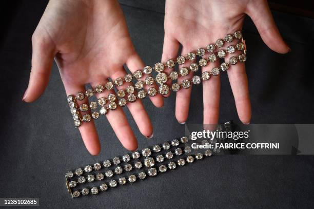 This picture taken in Geneva on September 6, 2021 shows two bracelets belonged to French Queen Marie-Antoinette adorned with three rows of 112 old...