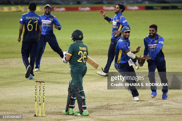 Sri Lanka's cricketers celebrate their victory by 78 runs at the end of the third one-day international cricket match between Sri Lanka and South...