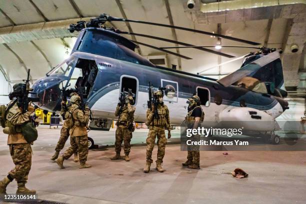 Taliban fighters from the Fateh Zwak unit, wielding American supplied weapons, equipment and uniforms, storm into the Kabul International Airport to...