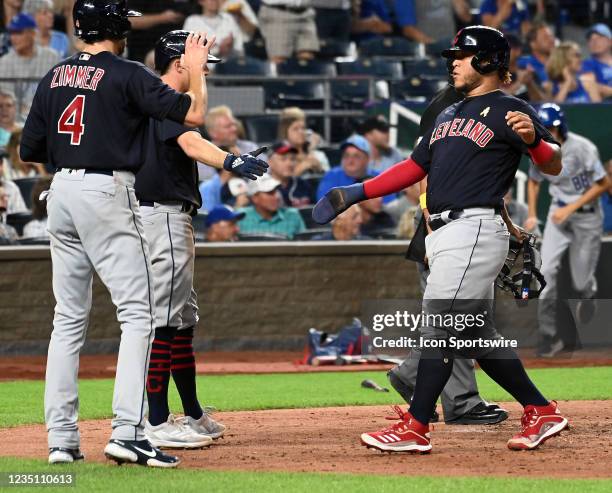 Cleveland Indians left fielder Harold Ramirez is congratulated at the plate after scoring during a Major League Baseball game between the Cleveland...