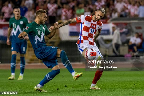 Marcelo Brozovic of Croatia and Sandi Lovric of Slovenia fight for the ball during the 2022 FIFA World Cup Qualifier match between Croatia and...