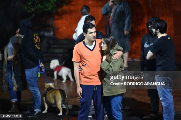 People remain outside their houses after a quake in Mexico City, on September 7, 2021. 9 magnitude earthquake struck Mexico on Tuesday near the...